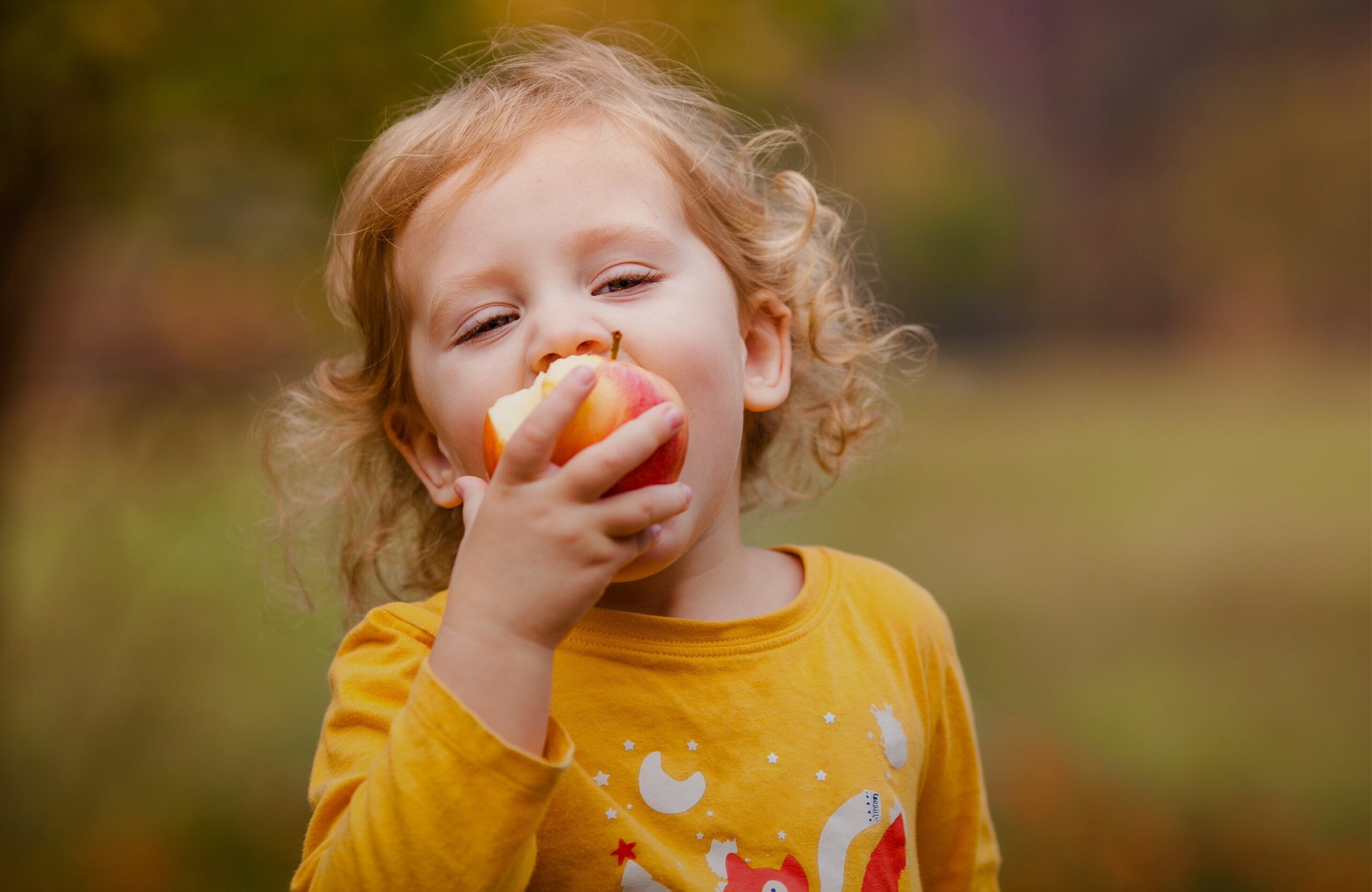 child eating an apple