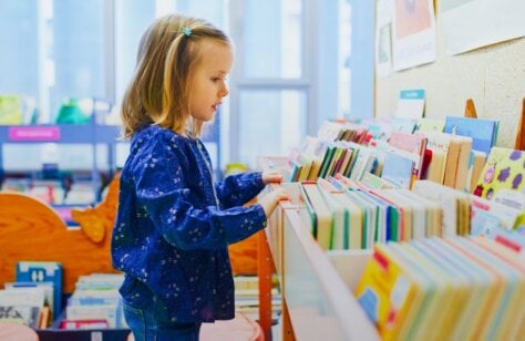 Girl choosing book at library